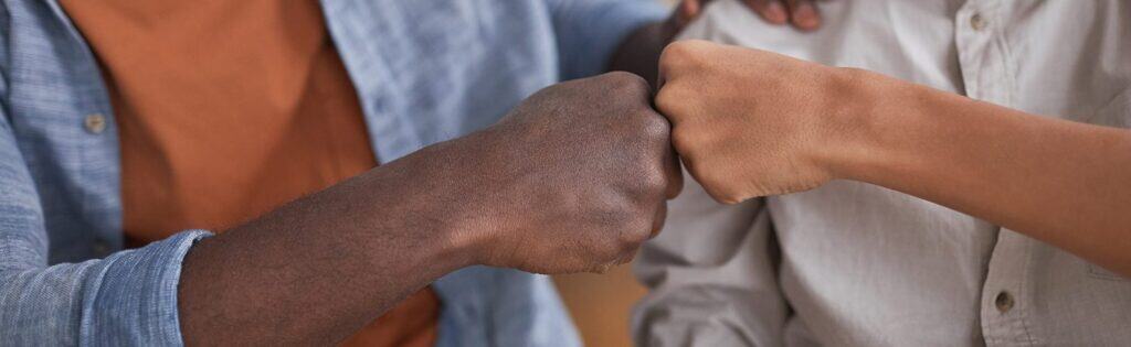 BFFs bumping fists symbolising support and camaraderie, promoting The Study Buddy's platform for student peer support and collaborative learning.