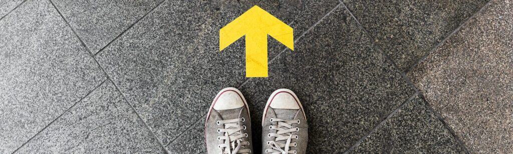 Floor with yellow arrow pointing upwards towards the study buddy website logo.