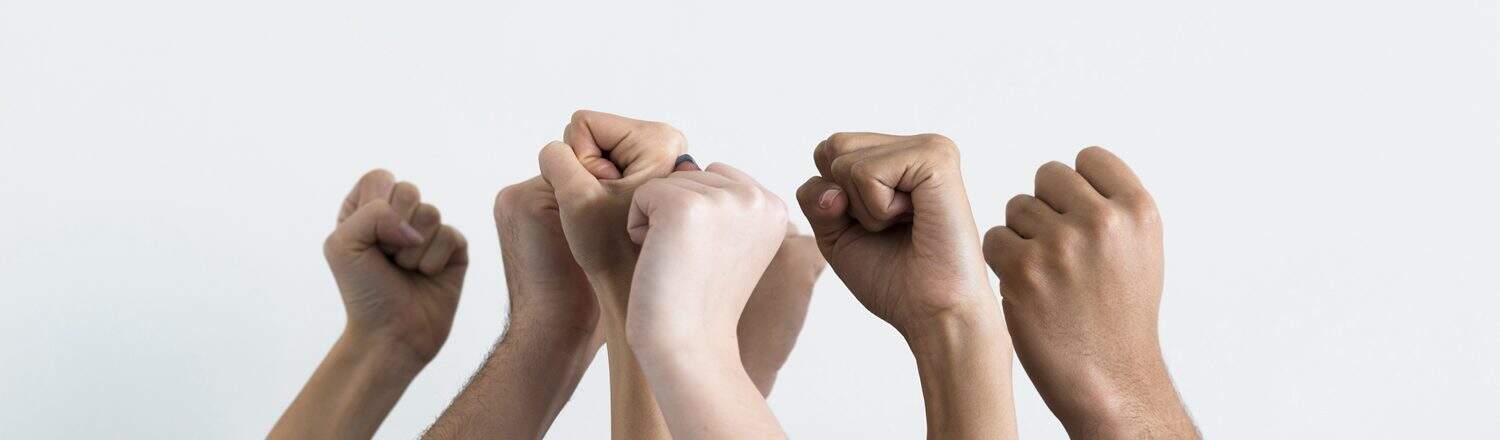 Supportive hands raised in unity symbolising community and collaboration on The Study Buddy website for student success.