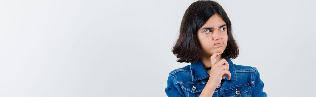 Being a girl in a denim jacket thinking deeply about the best way to study with The Study Buddy website for effective learning.