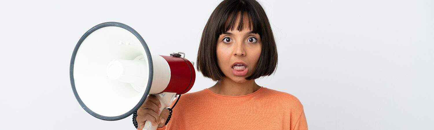 Megaphone woman looking surprised, the study buddy website, focus on online educational support and tutoring services offered by The Study Buddy, helping students excel academically through personalised assistance and resources.